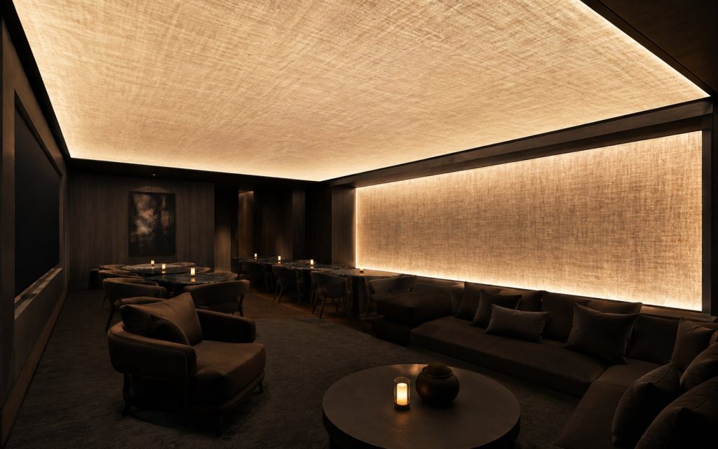 Acoustic luminous ceiling and matching wall panel in a dark room